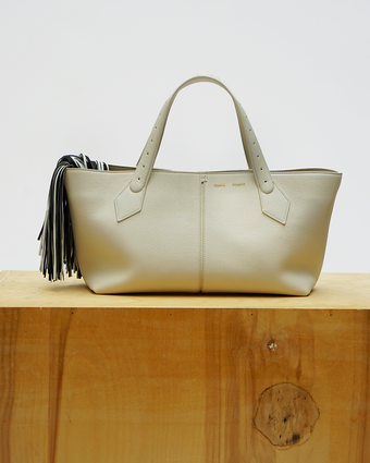 Still life image of the East West Chelsea Tote on a wood plinth against a white wall