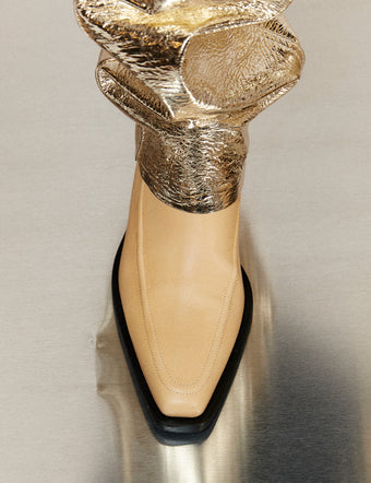 Cropped image of model wearing Bronco Boots in natural and Metallic Leather Pants