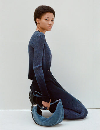 Model kneeling in Gradient Marl Cardigan and Skirt in steel grey/black