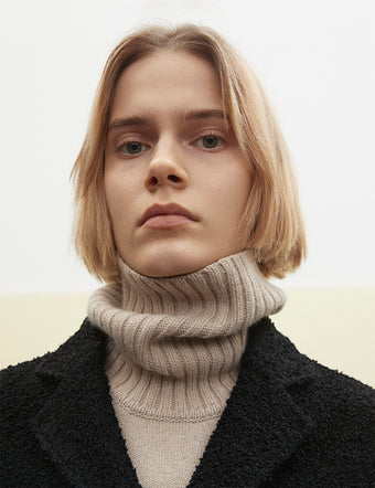 Cropped image of model in Doubleface Eco Cashmere Oversized Turtleneck Sweater in oatmeal and Boucle Coat in black