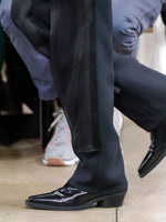 Image of model walking Proenza Schouler Fall Winter 2024 Runway wearing Bronco Ankle Boots in Brushed Calf in black