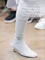 Image of model walking Proenza Schouler Fall Winter 2024 Runway wearing Tee Over The Knee Boots in Viscose Knit in grey