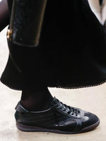 Image of model walking Proenza Schouler Fall Winter 2024 Runway wearing Track Sneakers in black