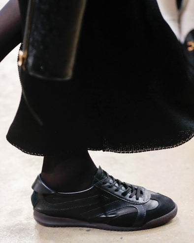 Image of model walking Proenza Schouler Fall Winter 2024 Runway wearing Track Sneakers in black