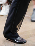 Image of model walking Proenza Schouler Fall Winter 2024 Runway Show wearing Tee Ankle Boots in black