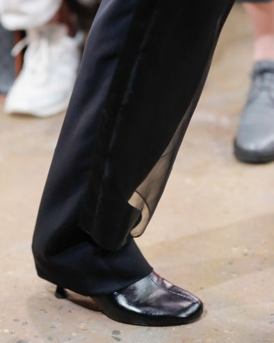 Image of model walking Proenza Schouler Fall Winter 2024 Runway Show wearing Tee Ankle Boots in black