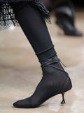 Image of model walking Proenza Schouler Fall Winter 2024 Runway wearing Tee Over The Knee Boots in Viscose Knit in black