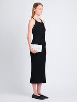 Image of model holding Flip Shoulder Bag in Optic White in hand as clutch