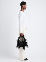 Image of model holding Park Shoulder Bag in Black Nylon with Feathers