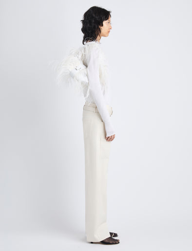 Image of model carrying Park Shoulder Bag in Optic White Nylon with Feathers on shoulder