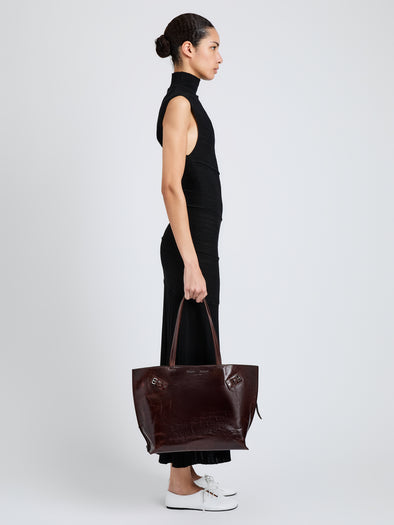Proenza Schouler Image of model wearing Days Tote in Pull Up Calf Skin in Dark Brown