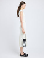 Proenza Schouler image of model carrying Silo Bag in Pieced Stripes in black/white