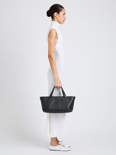 Proenza Schouler Image of model wearing East West Chelsea Tote in Pebbled Calf in Black