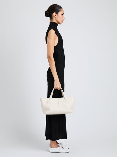 Proenza Schouler Image of model wearing East West Chelsea Tote in Pebbled Calf in Soft White