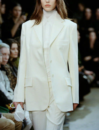 Cropped image of model walking Proenza Schouler FW24 Runway show wearing Archer Jacket and Teddy Pant in Wool Twill Suiting in wax