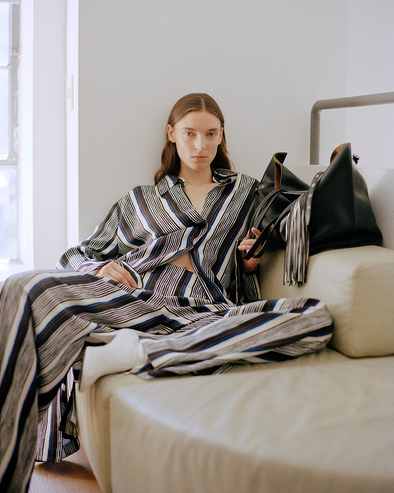 Proenza Schouler image of model sitting wearing Amira Pant in Printed Silk Habotai in Black Multi