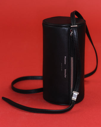 Image of the Black leather Crossbody Silo on Red background