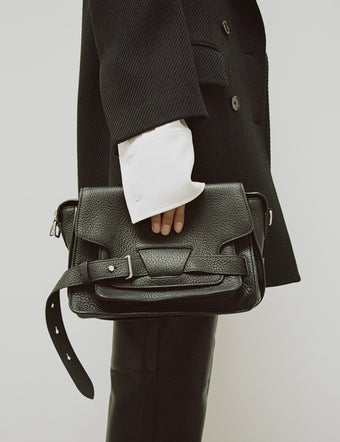 Cropped image of model holding Beacon Bag in black