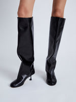 Image of model wearing Tee Knee High Boots in black