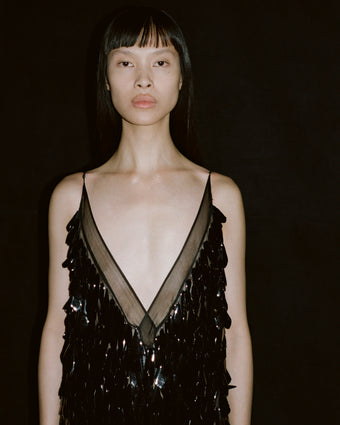 Image of model Diane Chiu wearing the black embroidered organza Irene Dress against a black background