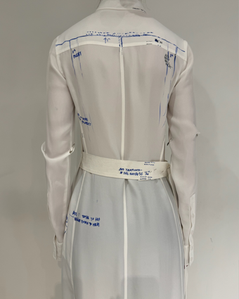 4x5 iPhone image of the back of the Hannah Dress from close up, with blue pen markings on the white prototype dress