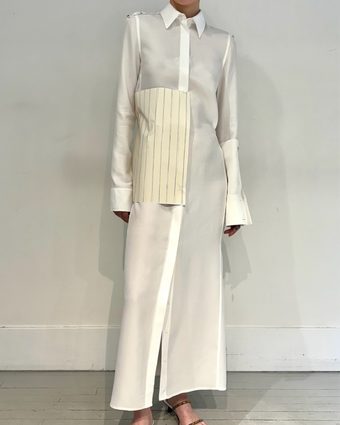 4x5 iPhone image of the Hannah Dress in fittings, with a piece of striped paper pinned to a white prototype dress