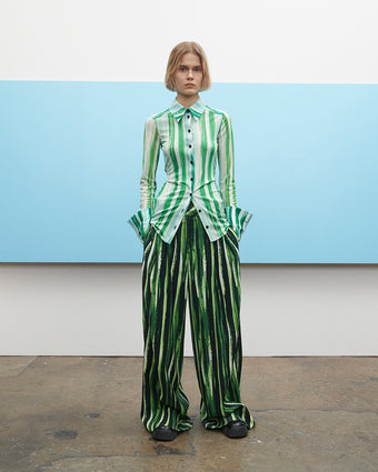 video of a model wearing the painted stripe top and bottom walking back and forth on a white background
