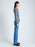 Side image of model wearing Jeanne Polo Sweater in Eco Cashmere in grey melange