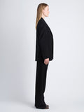 Side image of model wearing Devon Jacket In Viscose Wool in black