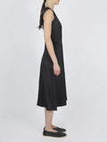 Side image of model wearing Ella Dress in Matte Satin in black