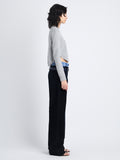 Side full length image of model wearing Stella Sweater In Cashmere Jacquard in GREY MELANGE