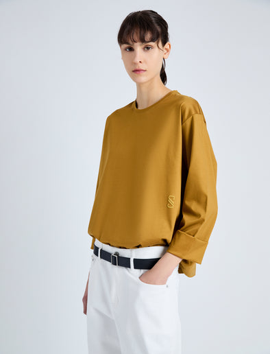 Detail image of model wearing Olson T-Shirt in Eco Cotton Jersey in CIDER