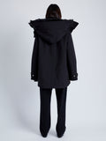 Back full length image of model wearing Wilder Coat In Technical Nylon in Black