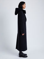 Side image of model wearing Reed Coat in Brushed Melange Wool with Hood in charcoal melange