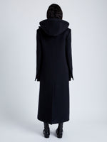 Back image of model wearing Reed Coat in Brushed Melange Wool with Hood in charcoal melange