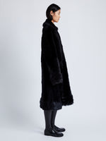 Side full length image of model wearing Fiona Coat In Sheared Toscana in Black