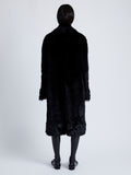 Back full length image of model wearing Fiona Coat In Sheared Toscana in Black