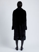 Back full length image of model wearing Fiona Coat In Sheared Toscana in Black
