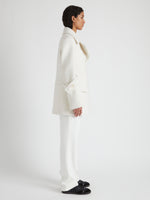Side image of model wearing Rowen Coat in Eco Double Face Wool in ecru