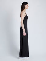 Side image of model wearing Bella Dress in Lacquered Viscose in black