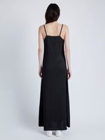 Back image of model wearing Bella Dress in Lacquered Viscose in black