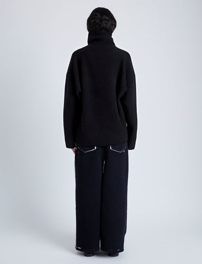 Back full length image of model wearing Yara Sweater In Double Face Cashmere in Black