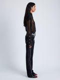 Side image of model wearing Ryman Jean in black multi
