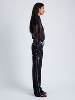 Side image of model wearing Ryman Jean in black multi