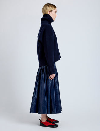 Proenza Schouler Side full length image of model wearing Petra Skirt in Lacquered Cotton in Navy