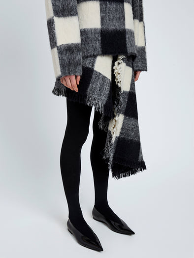 Proenza Schouler Detail image of model wearing Kai Skirt In Brushed Glenplaid Knit in Black Multi