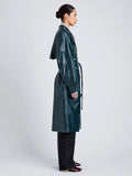 Proenza Schouler Side full length image of model wearing Benedetta Trench Coat in Coated Cotton in Bottle Green