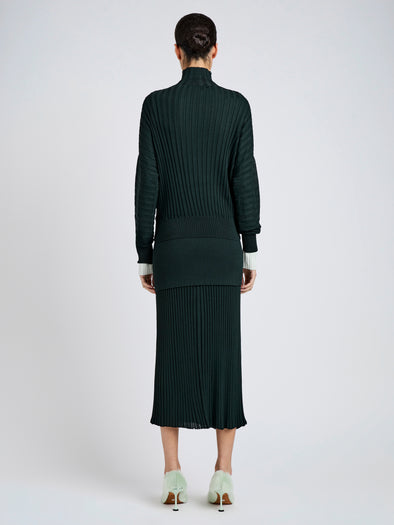 Proenza Schouler Back full length image of model wearing Luiza Skirt in Sunburst Rib in Bottle Green