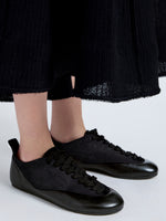 Proenza Schouler Image of model wearing Arcadia Sneakers in Black with black laces