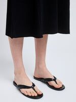 Image of model wearing Cable Thong Sandals in Black